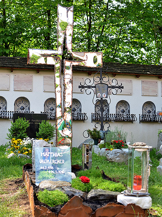 Grabkreuz aus spiegelpoliertem Stahl und rostigen Schweißnähten