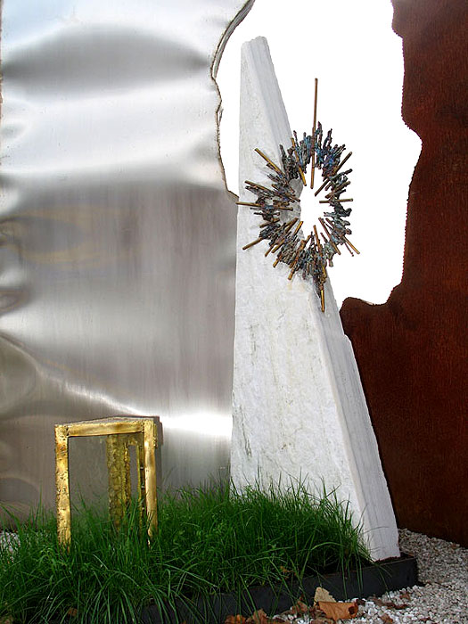 Upright white gravestone with welded aureole