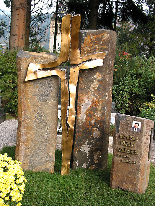Unique grave monument, Modern bronze cross with brown stones 